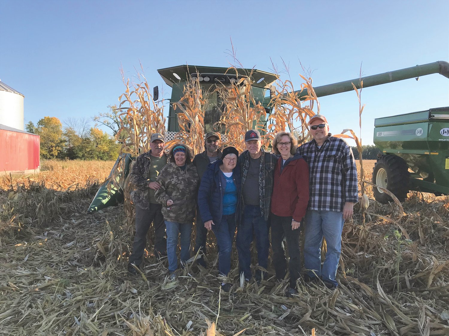 Members of the McBee family pose in a field during harvest this year. Four generations of the McBee family have worked the farm started by Jerry’s grandfather, Martin Z. McBee in 1902. This year marks the end of that generational family farming.